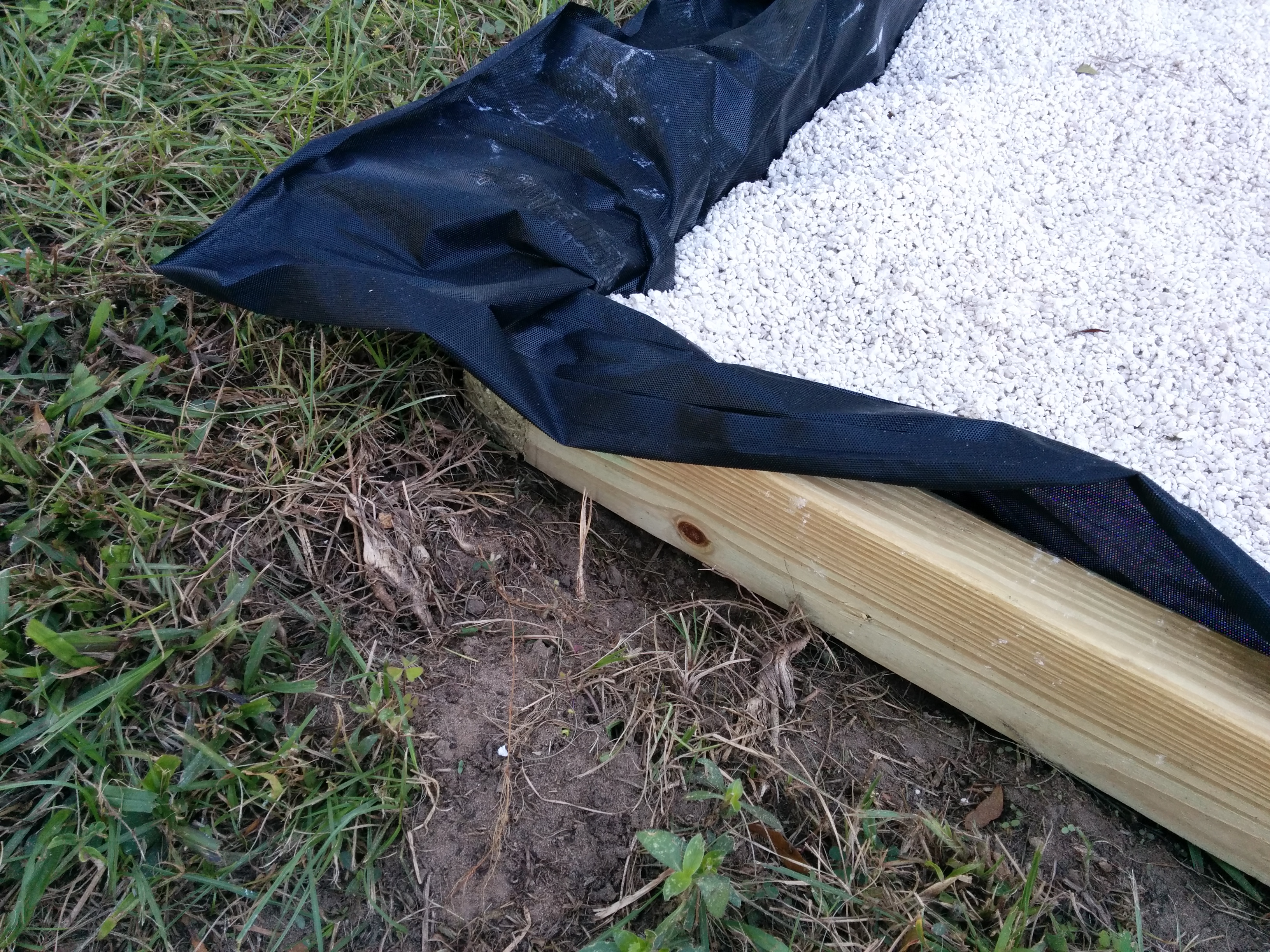 Patio edges showing weed block and paver base.